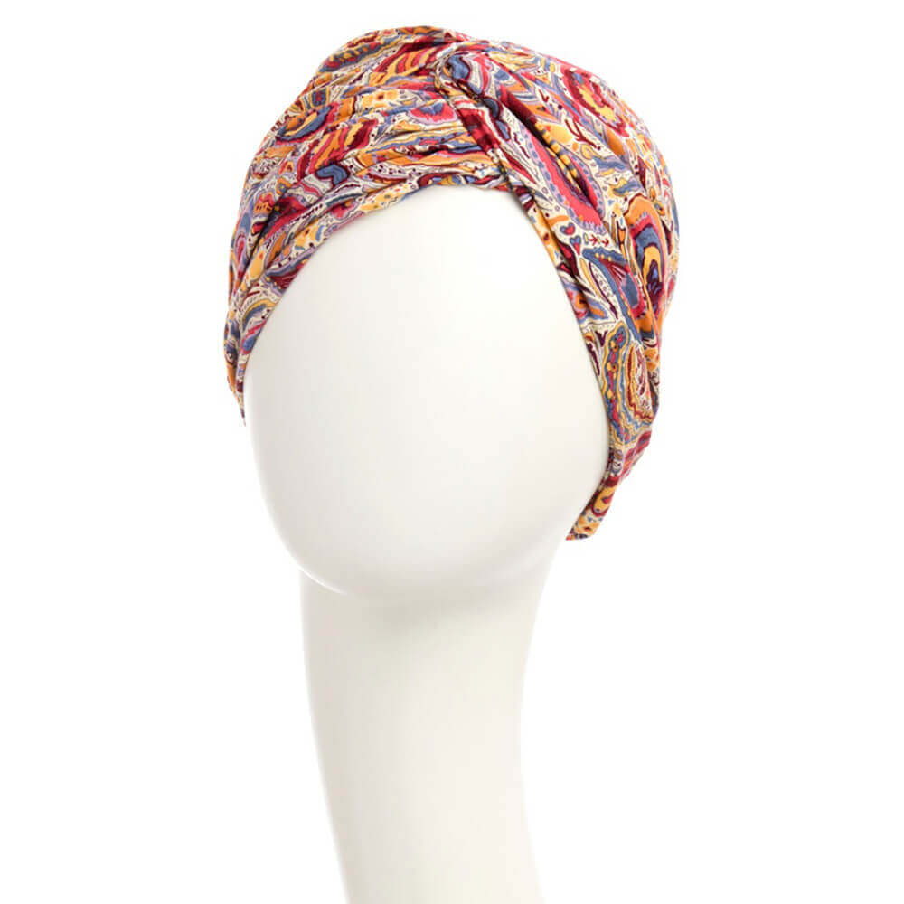 Feminin turban i et farverigt mønster med pink, orange, gule, blå og lyse farver
