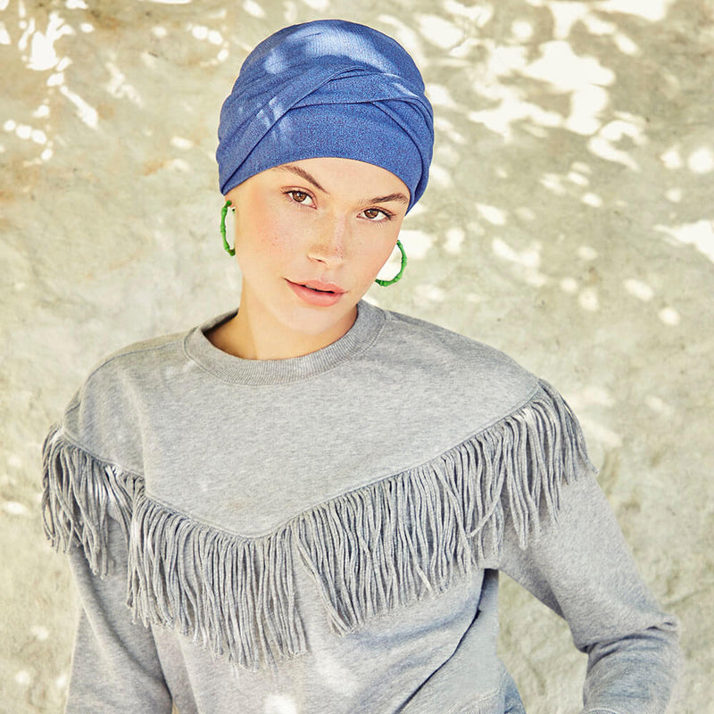 Elegant turban i frisk blåmeleret farve. Turban har pandebånd der er krydset.